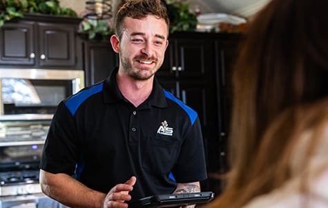 Acts of Service Plumbing technician talking with a homeowner